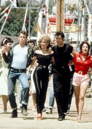 Grease cast walking through carnival fair