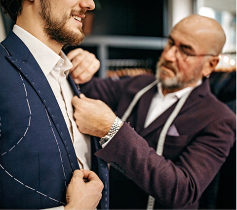 tailor and man trying on suit