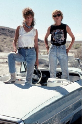 two women standing on car