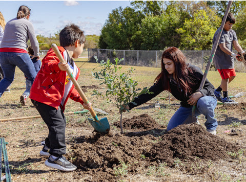 Woman and child planting tree