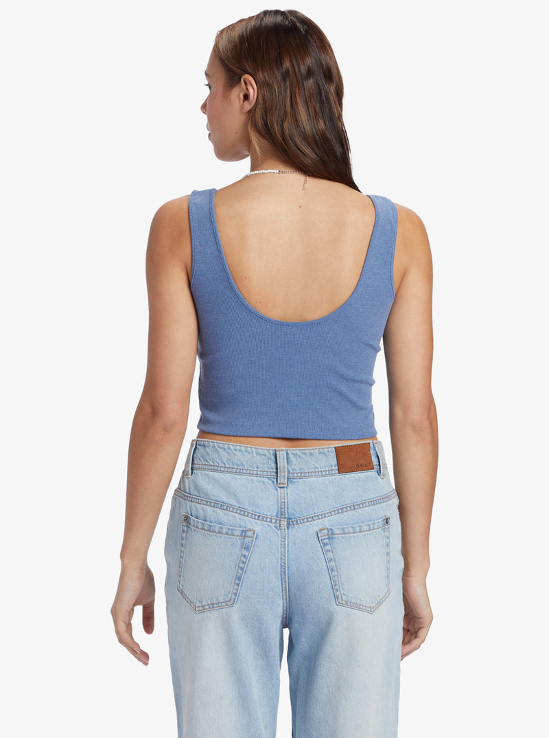 Back view of tank top. Features a low, scoop back with thick straps.
