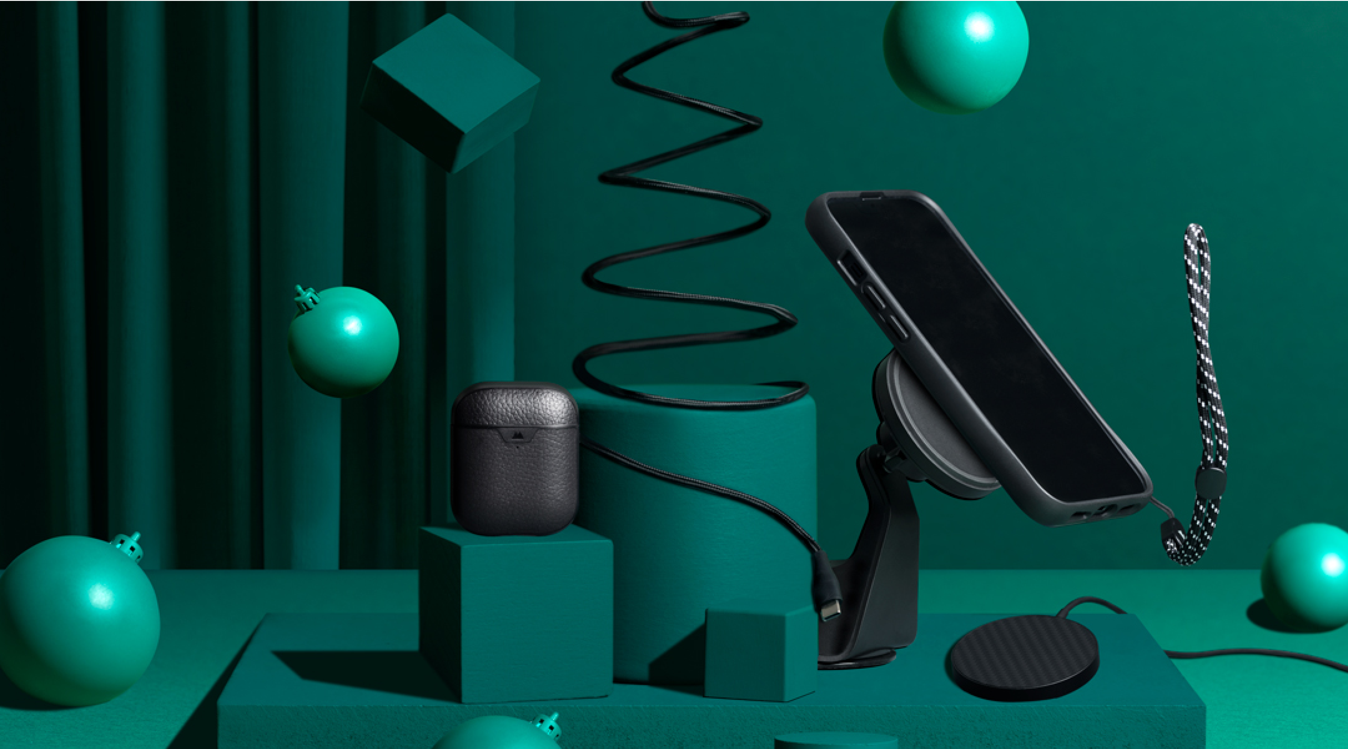 Mous ecosystem including protective phone case, AirPods case, MagSafe compatible wireless charger and christmas baubles