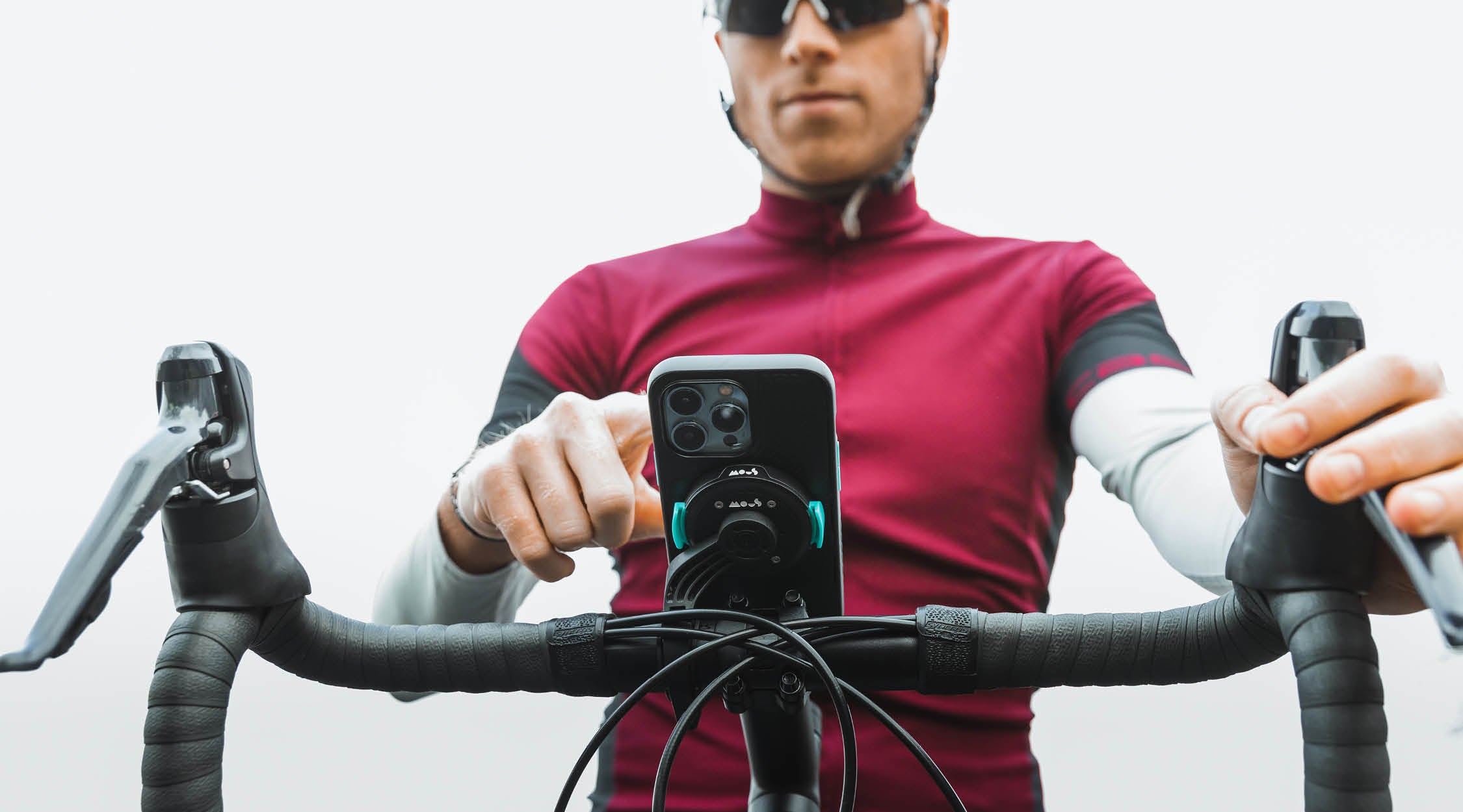 Man on a bike with Mous IntraLock secure phone bike mount and Evolution phone case for iPhone 13 Pro