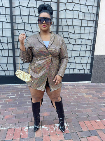 Morgan B. wearing a gold metallic blazer and black over the knee boots with black sunglasses