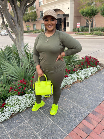 Morgan B. wearing an olive green two piece set with a neon green handbag and sneakers