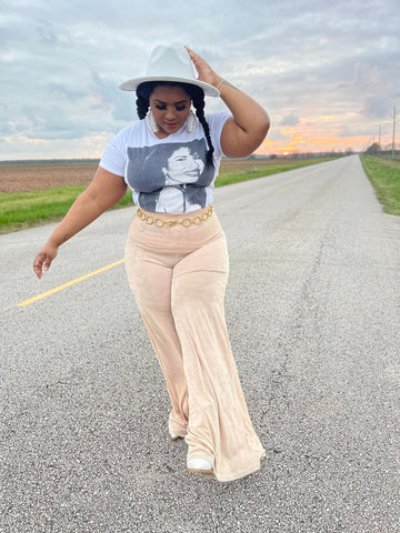 morgan b. wearing white gold chain fedora hat with graphic selena t-shirt, and nude overflow bell pants