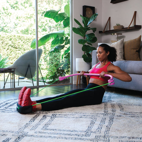 a woman performs resistance band training at home