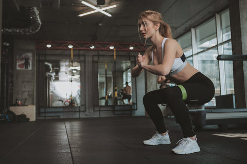 woman doing squat resistance workout