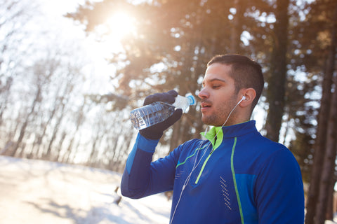 man drinking water during winter exercise