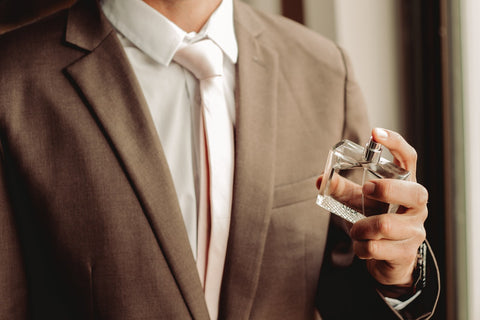 Man holding a perfume bottle