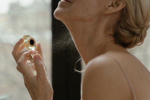 Woman applying pheromone perfume