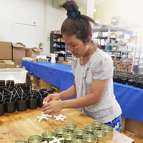 Candle-maker Sui skillfully pours and prepares soy blend candles at Prosperity Candle.