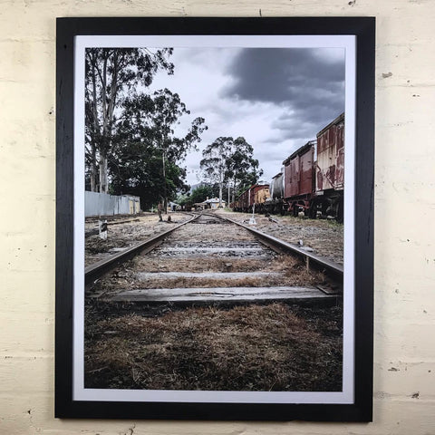 Black picture frame around railroad pic