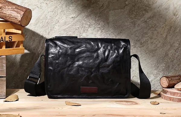 Stylish black crossbody bag featuring vegetable-tanned leather construction