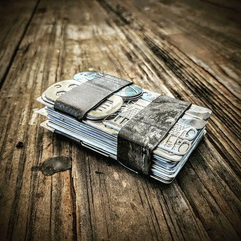 The Grim Workshop Survival Wallet. A multi tool wallet with minimalist survival kit cut into it's surface.