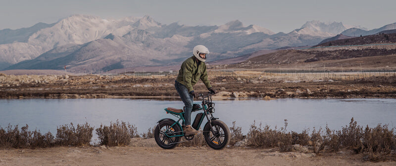 a man stands on the best electric fat tire bike - engwe m20