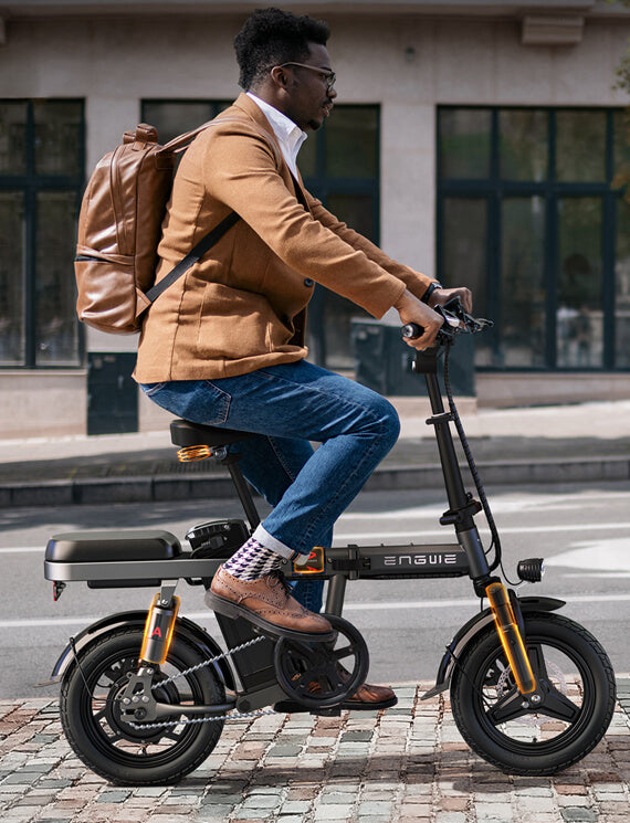 a man rides an engwe t14 electric mini bike on the road