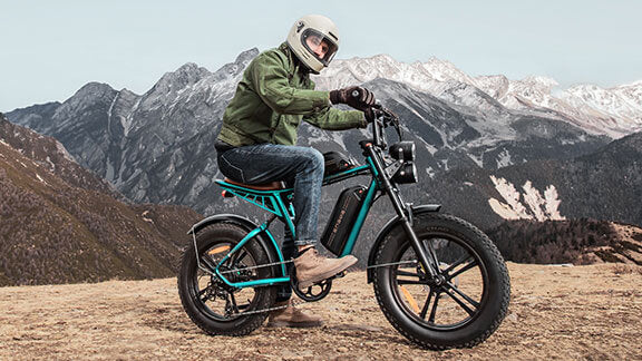 a man sitting on a fat tire electric bike - engwe m20