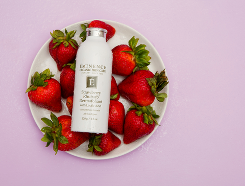 Eminence Organic skin care strawberry rhubarb dermafoliant laying on plate of strawberries The Best Organic Skincare Routine For Dry Skin Eminence Organics The Facial Room