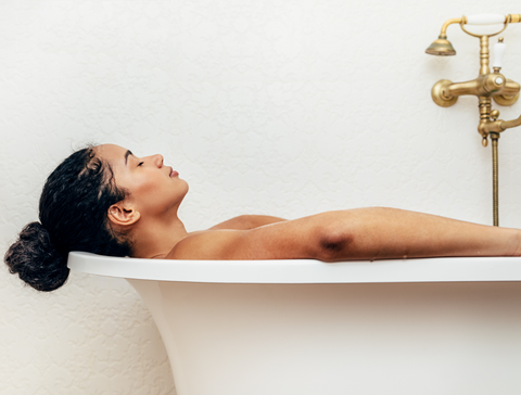 woman laying in a warm bath The Best Organic Skincare Routine For Dry Skin Eminence Organics The Facial Room