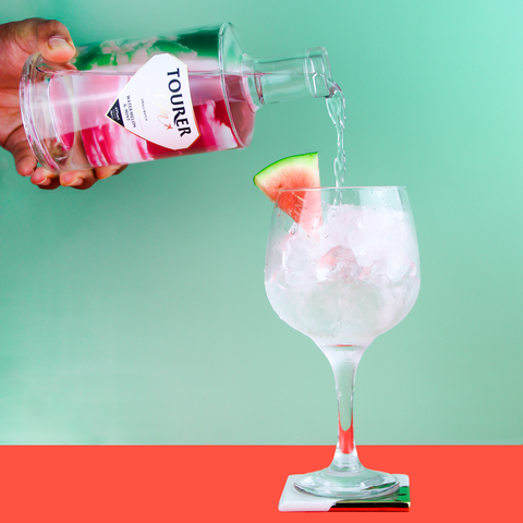 Tourer watermelon gin being pouring into gin glass