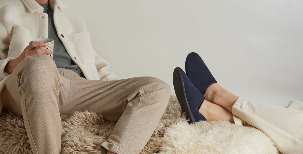 people relaxing in slippers with their feet up on a cosy couch