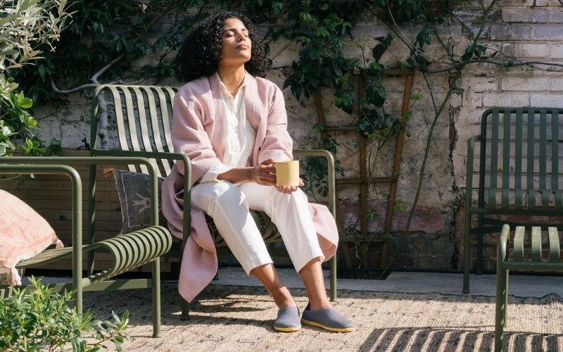 woman relaxes in garden with her breathe summer slippers