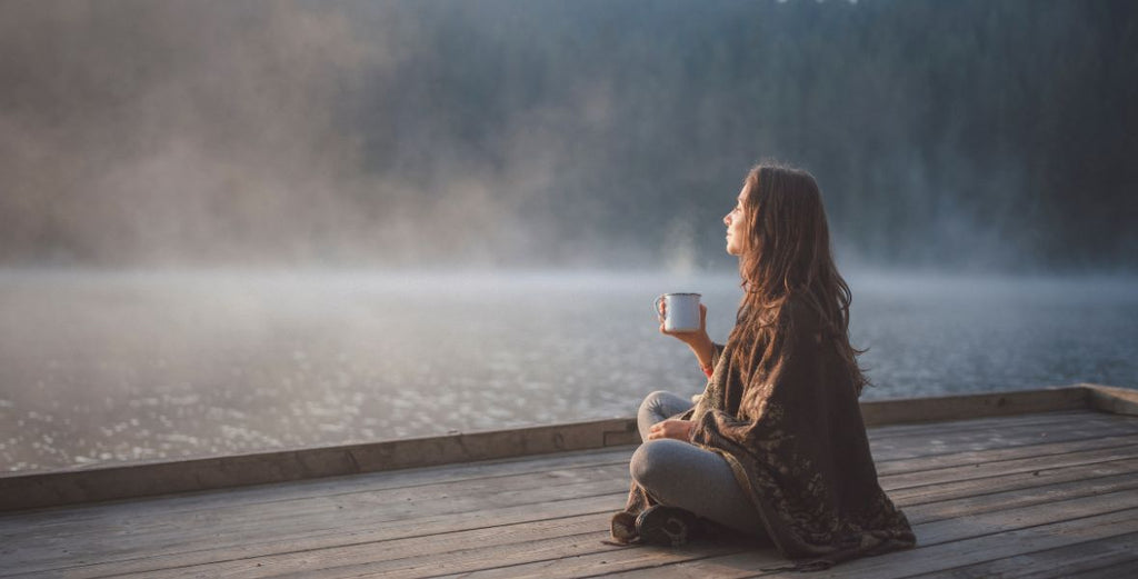 woman meditates on a doc