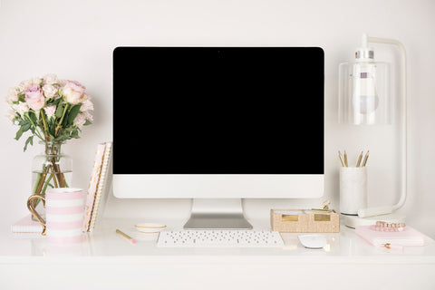 minima basics desk set up with mac flowers lamp and desk organization