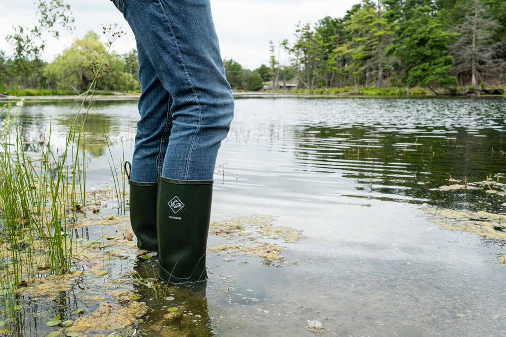 wading water in a pair of mudder muck boots