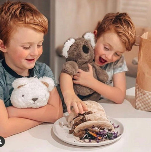 children holding stuffed toys