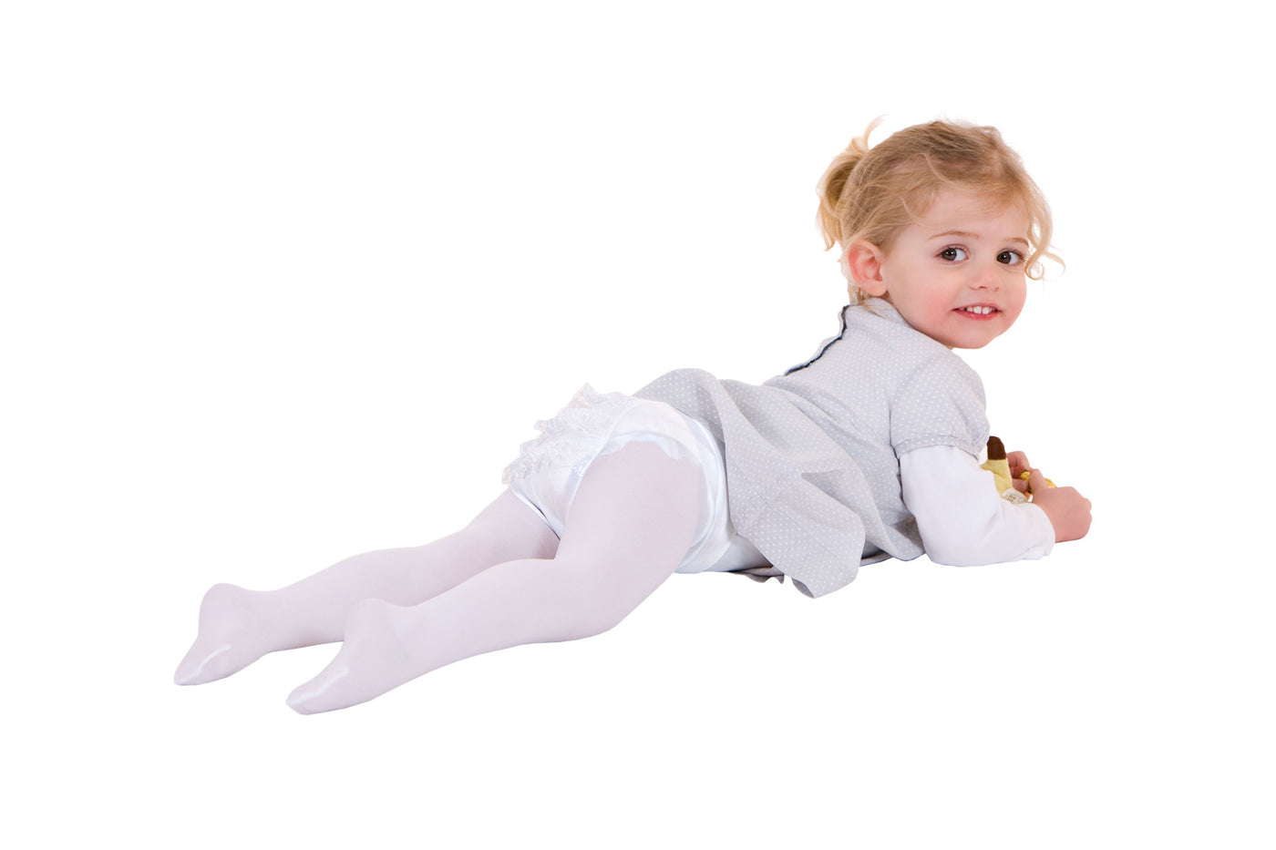 Smiling little girl wearing sport clothing standing in studio Stock Photo