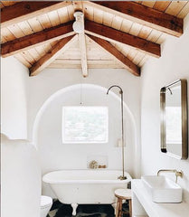 clawfoot bath with a simple cabinet