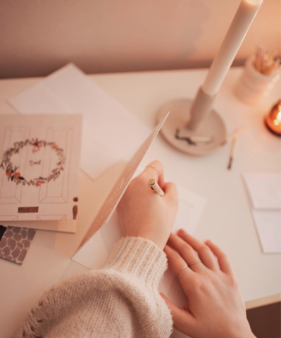 A girl writing in Christmas cards by Mimi & August