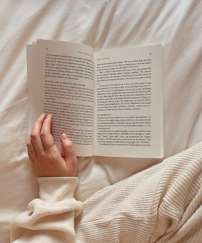 A simple picture of an open book in a white bed