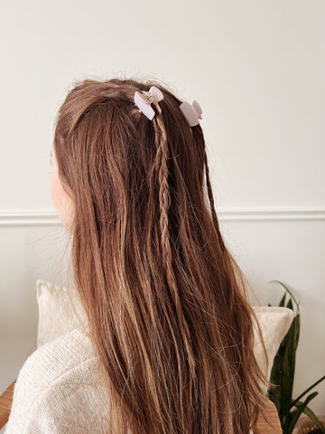 A girl with brown hair and small sided braids with Milan's mini claw clips from Mimi & August