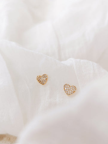 Heart shaped Zircon earrings by mimi and august laid on a blanket 