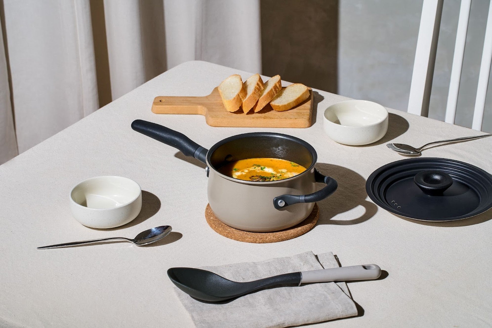 Serve a steaming bowl of pumpkin soup directly from a Meyer nonstick saucepan, complete with a small universal lid and an everyday nylon spoon on the dining table