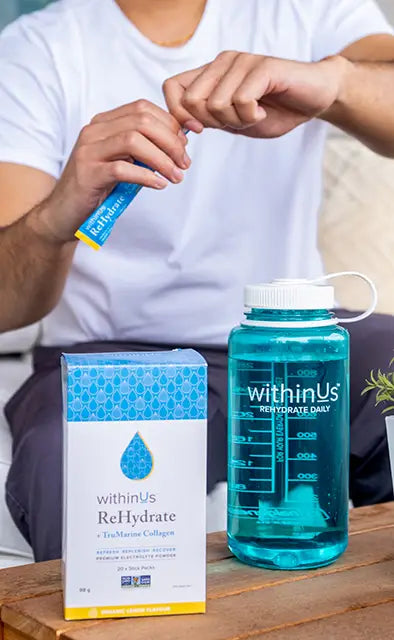 Man mixing up Rehydrate Lemon + TruMarine® Collagen in our reusable bottle.