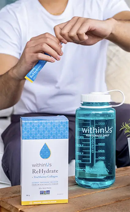 Man mixing up Rehydrate Lemon + TruMarine® Collagen in our reusable bottle.