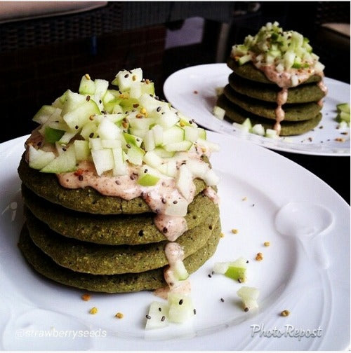 Healthy and balanced recipe with homemade pancakes with matcha green tea, served with vegan almond butter, apples and chia seeds