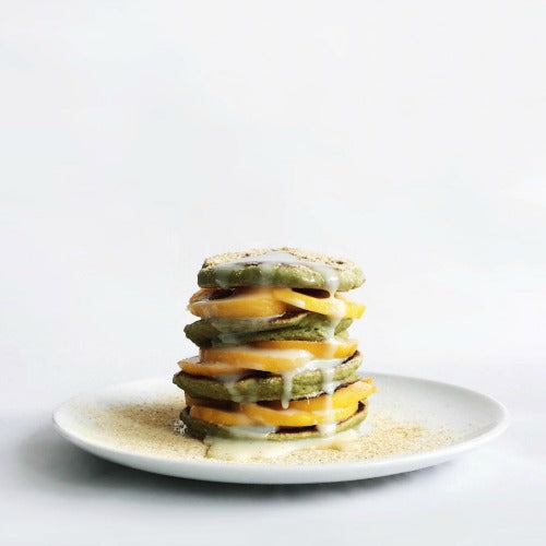 Homemade matcha pancakes served with fruits and topped with kinako