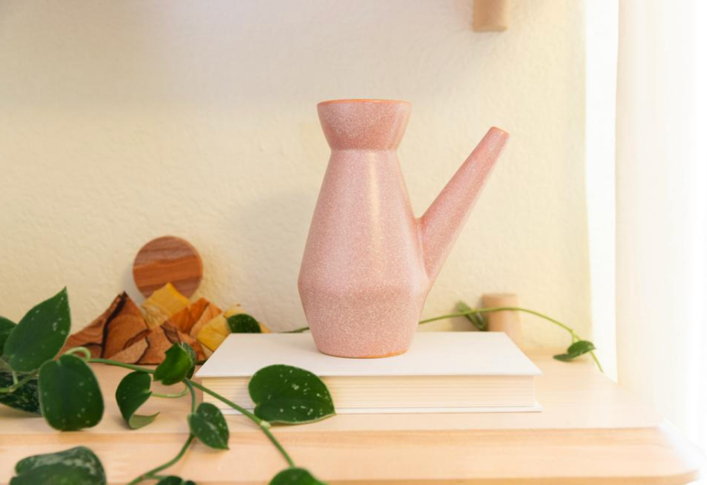 Pink ceramic watering can