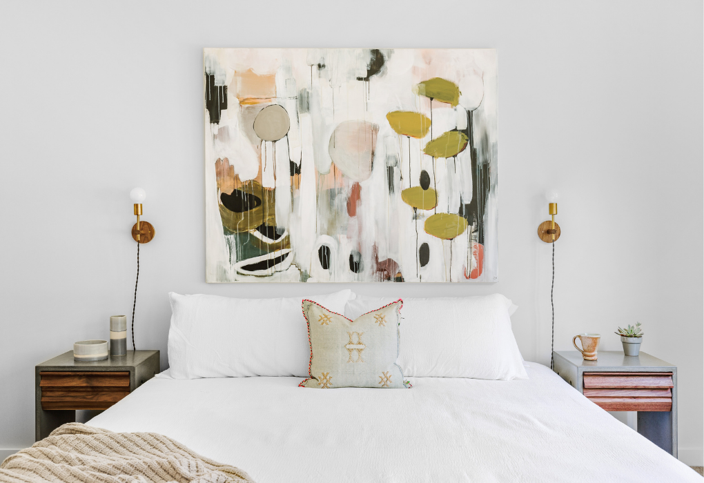 Bedroom with a large abstract wall art above the bed