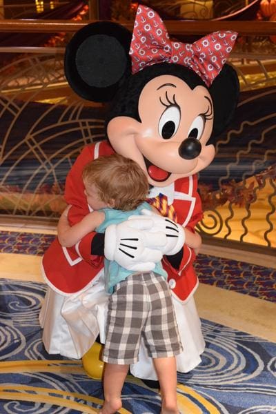 Minnie Mouse hugging toddler on Disney cruise