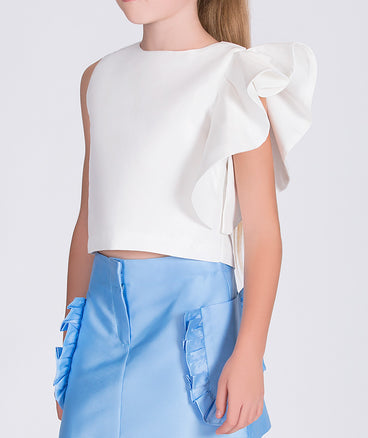 white blouse with ruffled sleeve and blue skirt with ruffled pockets