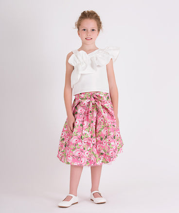 white ruffled one shoulder blouse and pink floral skirt