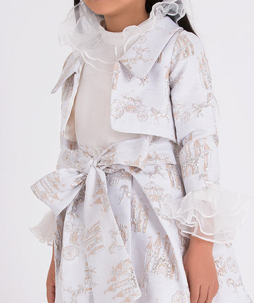 white organza ruffled blouse with silver jacqaurd jacket and skirt set that has shimmering castle and horse carriage embroideries