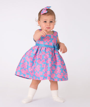 blue baby dress with pink floral prints and bow on the waist