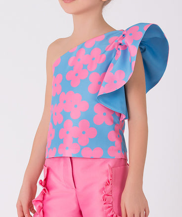 blue one shoulder blouse with pink flower prints and pink pants